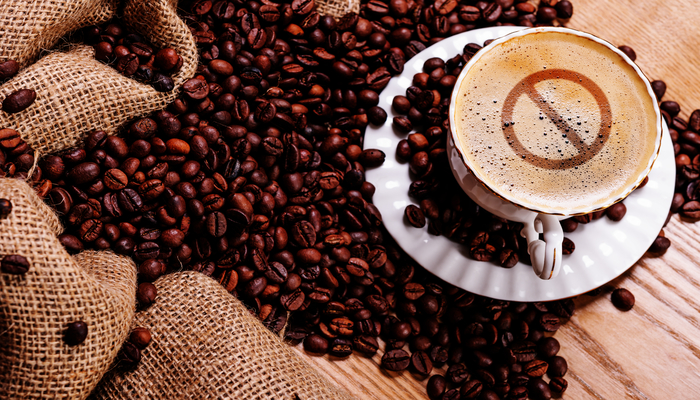 Coffee beans and a cup of coffee | DNAfit Blog
