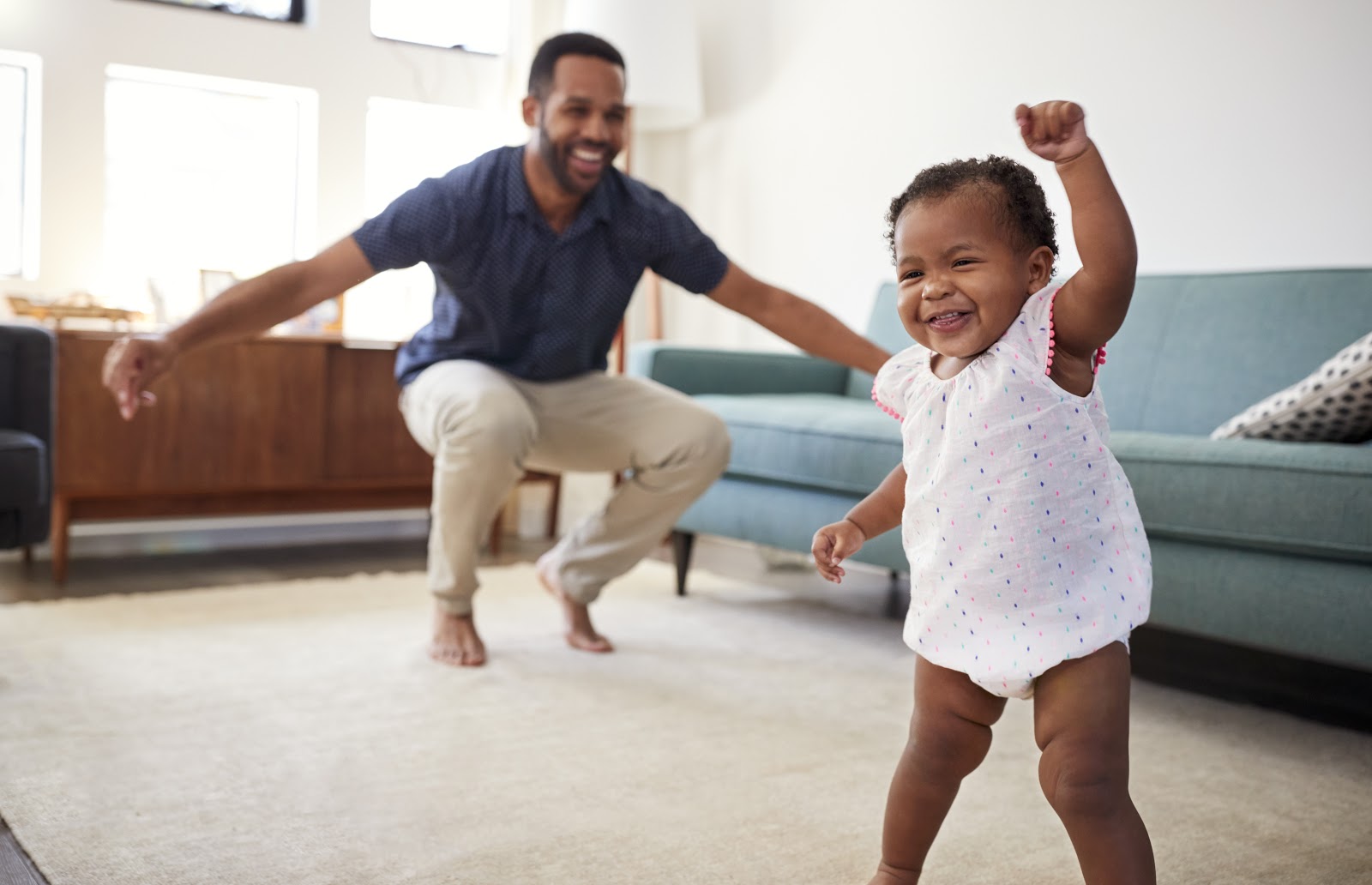 Father dancing with his baby daughter in their house | DNAfit Blog